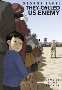Cover of the graphic memoir They Called Us Enemy showing a young Japanese American boy looking back while standing in line with his family, each carrying luggage, as they are escorted by an armed guard toward a fenced internment camp with watchtowers in the background.